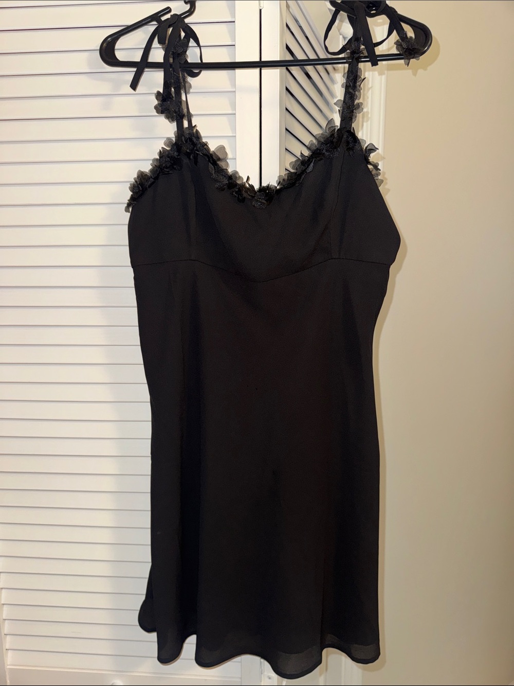 Black chiffon dress with adjustable tie straps and smocked back.